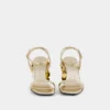 Sandalias doradas con tacones de disco Sparkle